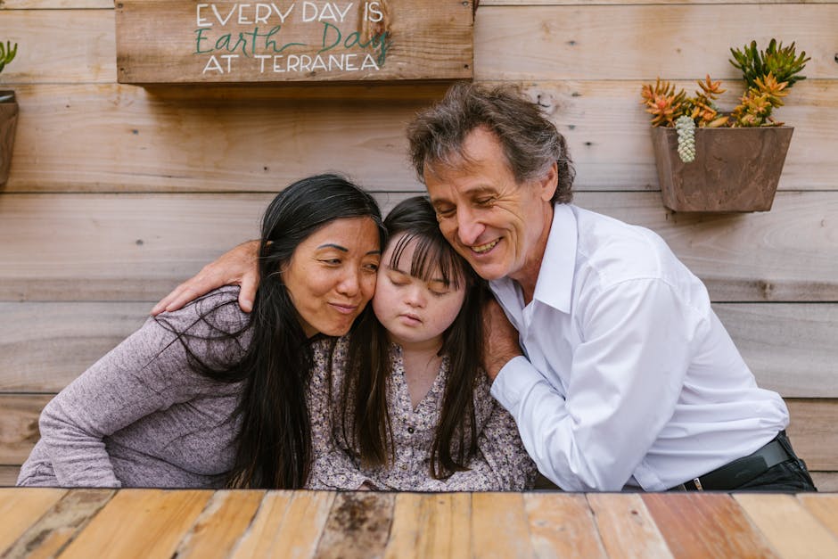 A family warmly embraces their daughter, showing love and support in an outdoor setting.